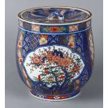 Japanese porcelain covered jar, decorated with plants and trees of the seasons in reserves, lid with