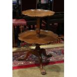 Chippendale style dumb waiter, the two tier table having a shaped rim, rising on a tripod base and