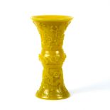 Chinese yellow Peking glass vase, of gu form with flowering prunus to the gnarling branches, 8.5"h