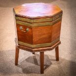 Regency wine cooler circa 1810, the octagonal form executed in mahogany, having brass bands and