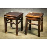 (lot of 2) Chinese hardwood stools, each inset with a square floating panel, above a plain apron and