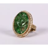 Carved jadeite, seed pearl and 14k yellow gold ring Centering (1) carved jadeite plaque, measuring