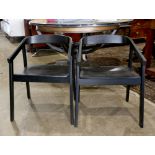 Pair of Moderne style ebonized armchairs, having a barrel back, 28"h x 20"w x 18.5"d