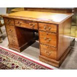 George III kneehole desk, late 18th century, having an inset leather top, above the seven drawer