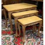 (lot of 3) French provincial nesting tables, having a carved apron and rising on cabriole legs,