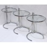 (lot of 3) Eileen Gray chrome and glass adjustable side tables, each having a circular adjustable