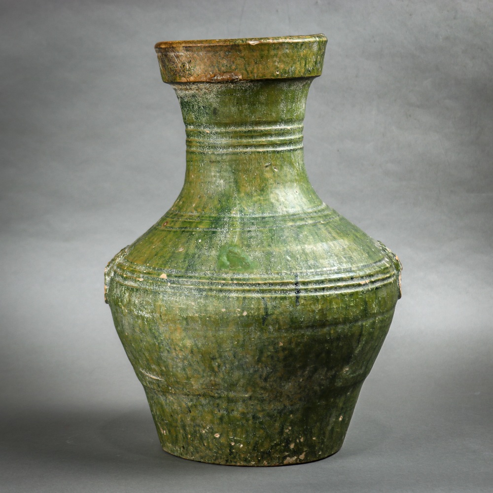 Chinese Han green glazed ceramic vase, with a trumpet neck above the wide shoulders and tapering