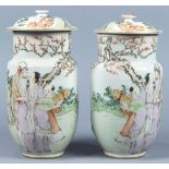 Pair of Chinese enameled porcelain urns, the wide cylindrical neck set above a tapering body,