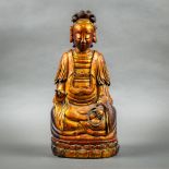 Chinese gilt lacquered wood deity, seated on a lotus pedestal and holding a strand of prayer beads