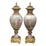 Pair of monumental gilt bronze mounted Sevres polychrome decorated urns, each having a scenic