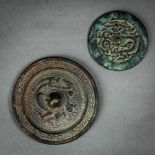 (lot of 2) Chinese bronze mirrors, both with stylized dragons, and with a knob to the center,