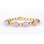 Jadeite and 18k yellow gold bracelet Featuring (4) oval lavender jadeite cabochons, measuring