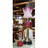 (lot of 2) Victorian cranberry glass kerosene lamps, consisting of a small Bristol Glass example,