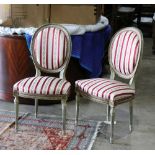 Pair of Louis XVI style side chairs, having an oval back with partial gilt decoration and rising