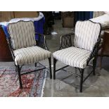 Pair of faux bamboo armchairs, the frame with a black lacquered finish, above the striped