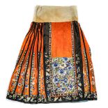 Chinese orange silk skirt, pleated with black trim, satin stitch embroidered with blue-and-white