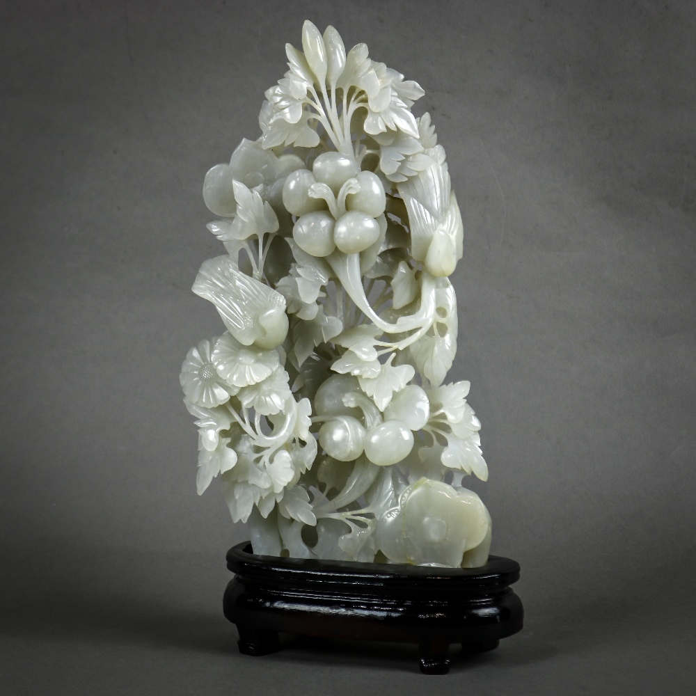 Chinese hardstone sculpture, carved and pierced with birds amid various flowering bushes and a