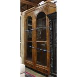 English burlwood bookcase, the two door case with inset glass panels, opening to a fitted