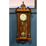 Vienna Regulator clock, having a walnut case having a single door opening to the circular dial
