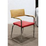 Swedish Zuco armchair, having a red upholstered seat, and rising on chrome legs, 33"h