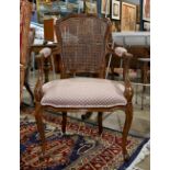 Louis XV style fauteuil, having a shaped caned back and rising on cabriole legs, 38.5"h x 23"w x