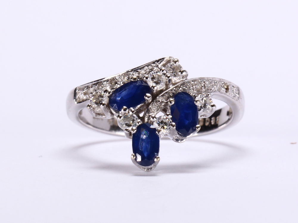 Sapphire, diamond and 14k white gold ring Featuring (3) oval-cut sapphires, weighing a total of