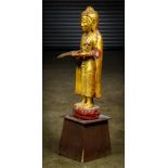 Southeast Asian gilt lacquered Buddha, standing on a lotus pedestal with his hands in bhumisparsha