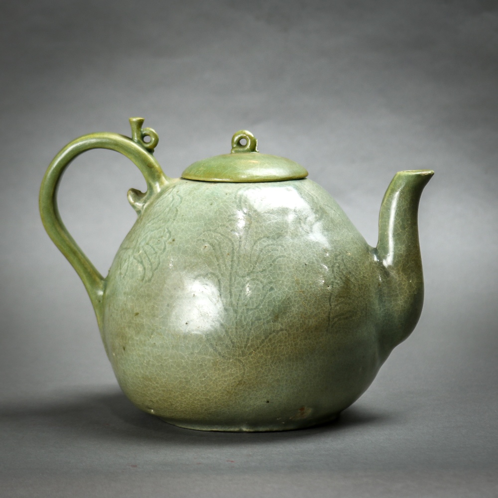 Korean celadon glazed ceramic teapot, the body of peach form incised with floral sprigs, topped by a - Image 2 of 6
