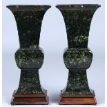 Pair of Chinese jade vases, of flattened gu-form, each with a flared trumpet neck above a bulbous