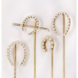 (Lot of 4) Seed pearl and yellow gold horseshoe stickpins Including (1) Shreve & Co seed pearl and