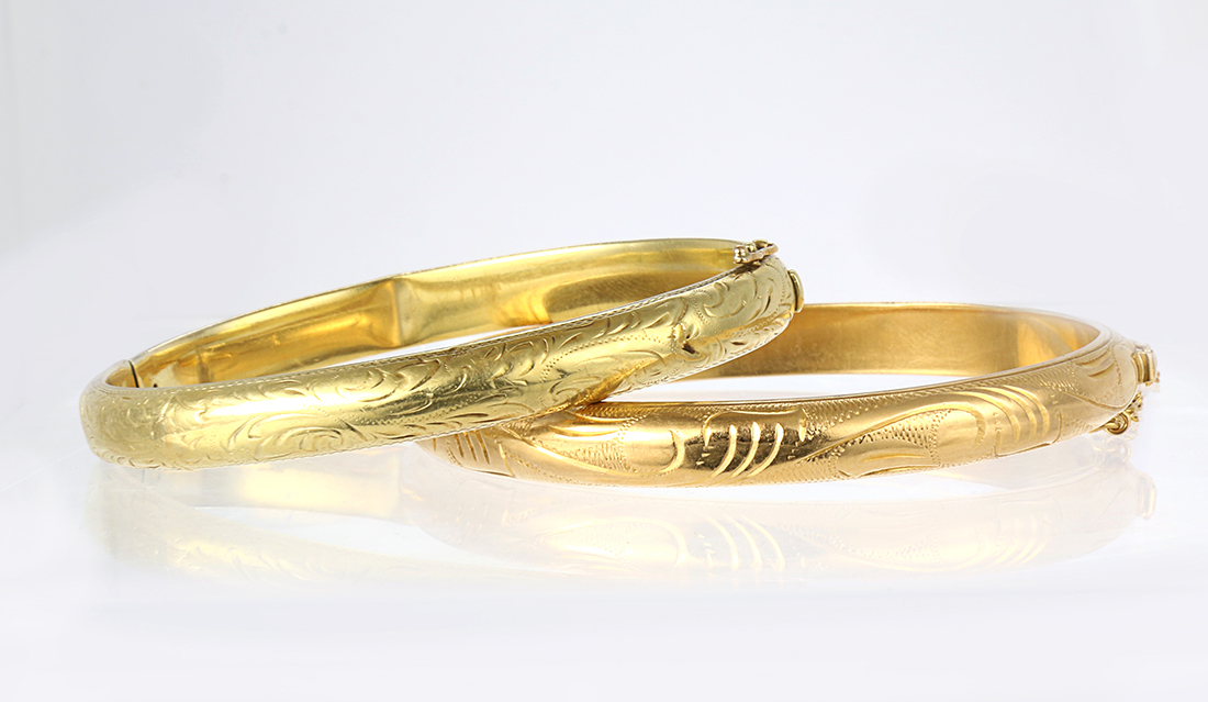 (Lot of 2) 14k yellow gold bracelets Including 1) 7.8 mm, 14k yellow gold hinged, engraved bangle