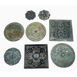 (lot of 8) Chinese bronze mirrors, including two of foliate edge with squirrel and grape motif;