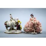 (lot of 2) German porcelain crinoline figural statues, the larger depicting a seated beauty with a
