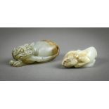 (lot of 2) Chinese jade/hardstone carvings, each of a recumbent mythical beast, one with a gray