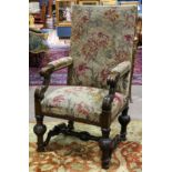 Continental carved fireside chair, the rectangular back covered in needlepoint with floral