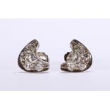 Pair of diamond and 10k white gold earrings Featuring (10) round-cut diamonds, weighing a total of