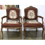 Pair of Louis XV Provincial style needlepoint armchairs, each having a carved foliate crest over the