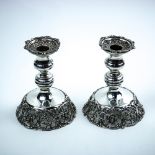 Pair of American Rococo Revival style sterling silver single light candlesticks, the turned standard