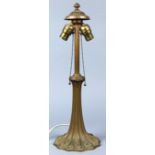 Art Nouveau style bronze lamp base, having a double socket, the fluted standard rising on a shaped