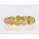 Diamond and 18k yellow gold eternity band Featuring (13) round-cut diamonds, weighing a total of