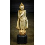 Burmese marble sculpture of the Buddha, adorned in monastic robe, with right hand across the left