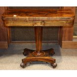 Regency games table, having a highly figured rosewood flip top above the faceted standard and rising