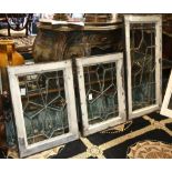 (Lot of 8) leaded glass window group, with clear, beveled and colored glass, inset into a wood