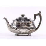 English sterling silver teapot, London 1821, having a carved wood handle, hinged lid and rising on