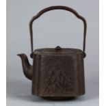 Japanese iron tetsubin kettle, 19th century, rounded square form body with landscape, inscribed "