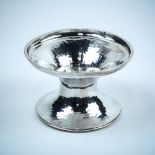 Victorian hammered silver salt, London 1893 by George Fox, the round bowl with wide rim, rising on a