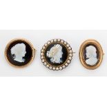 (Lot of 3) Agate cameo, half pearl and yellow gold brooches Including 1) carved onyx cameo,