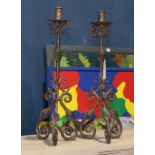 Pair of Spanish Colonial style candle holders, having a wrought iron standard and rising on scrolled