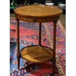 Federal style side table, having a circular top over the one drawer case, rising on turned legs