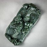 Chinese spinach jade palette dish, in the form of cresting waves, centered with a sacred jewel, 8"w;
